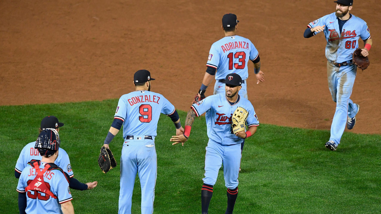 MINNEAPOLIS, MINNESOTA - SEPTEMBER 26: Eddie Rosario #20 of the Minnesota Twins celebrates defeating the Cincinnati Reds without any shoes on after leaving them for a member of the grounds crew after the game at Target Field on September 26, 2020 in Minneapolis, Minnesota. The Twins defeated the Reds 7-3.