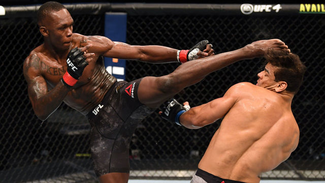 ABU DHABI, UNITED ARAB EMIRATES - SEPTEMBER 27: (L-R) Israel Adesanya of Nigeria kicks the head of Paulo Costa of Brazil in their middleweight championship bout during UFC 253 inside Flash Forum on UFC Fight Island on September 27, 2020 in Abu Dhabi, United Arab Emirates.