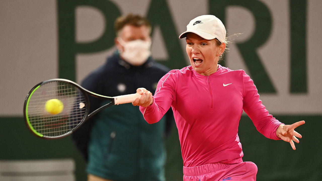 PARIS, FRANCE - SEPTEMBER 27: Simona Halep of Romania plays a forehand during her Women's Singles first round match against Sara Sorribes Tormo of Spain as a linesman looks on in the background wearing a face mask, which has been made compulsory due to the ongoing COVID-19 pandemic on day one of the 2020 French Open at Roland Garros on September 27, 2020 in Paris, France.