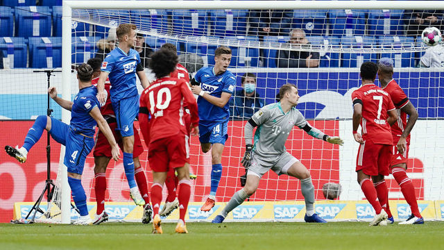 27 September 2020, Baden-Wuerttemberg, Sinsheim: Football: Bundesliga, TSG 1899 Hoffenheim - Bayern Munich, 2nd matchday, PreZero-Arena. Hoffenheim's goal scorer Ermin Bicakcic (l) shoots past Munich goalkeeper Manuel Neuer (3rd from right) to score the goal for 1:0. Photo: Uwe Anspach/dpa - IMPORTANT NOTE: In accordance with the regulations of the DFL Deutsche Fußball Liga and the DFB Deutscher Fußball-Bund, it is prohibited to exploit or have exploited in the stadium and/or from the game taken photographs in the form of sequence images and/or video-like photo series.