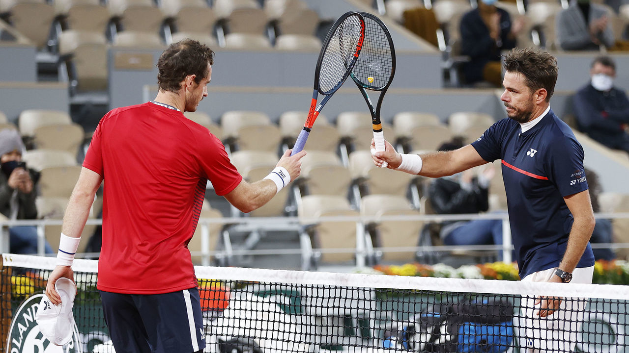 PARIS, FRANCE - SEPTEMBER 27: Stan Wawrinka of Switzerland (R) knocks racquets with Andy Murray of Great Britain as part of COVID-19 precautions following victory in his Men's Singles first round match during day one of the 2020 French Open at Roland Garros on September 27, 2020 in Paris, France.