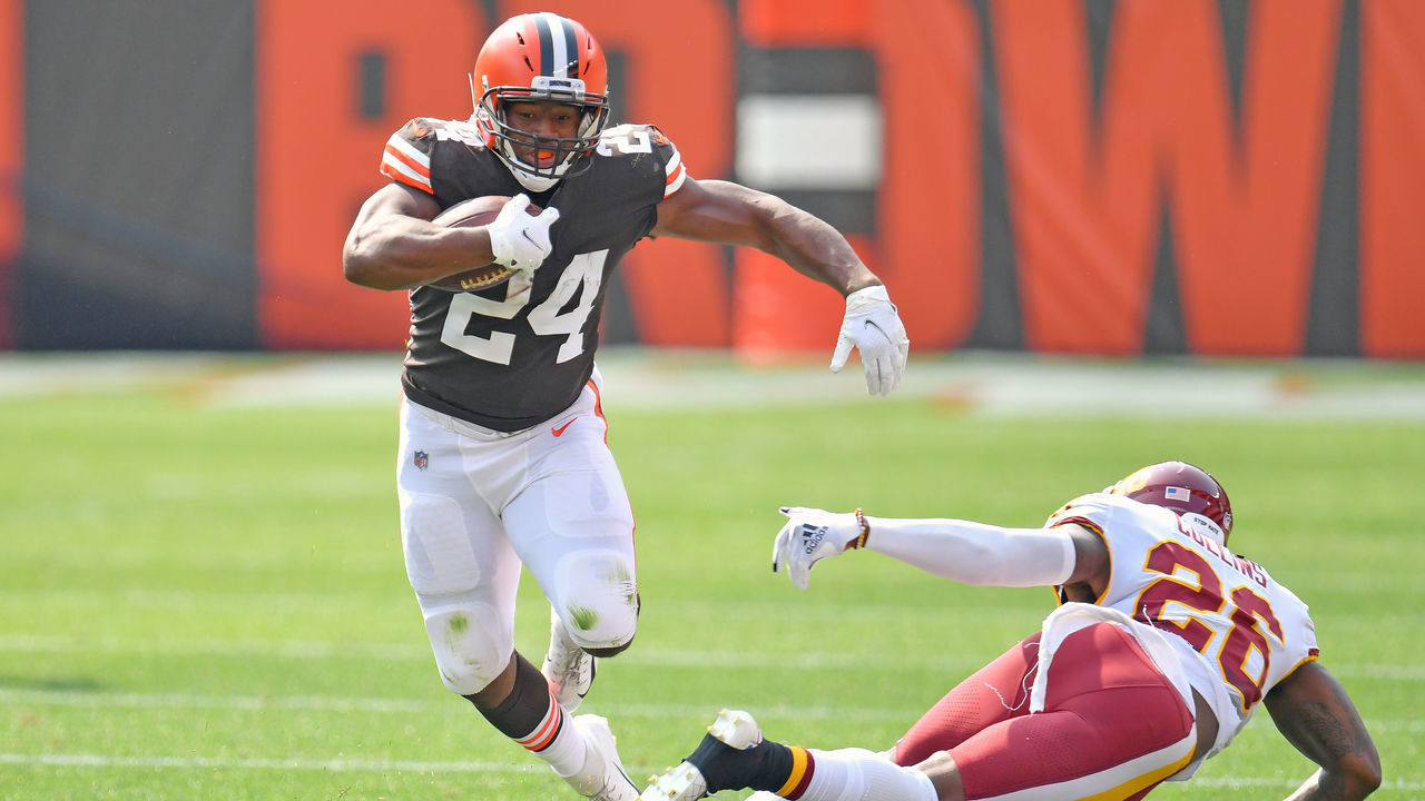 CLEVELAND, OHIO - SEPTEMBER 27: Running back Nick Chubb #24 of the Cleveland Browns breaks a tackle from strong safety Landon Collins #26 of the Washington Football Team as he runs for a first down at FirstEnergy Stadium on September 27, 2020 in Cleveland, Ohio.