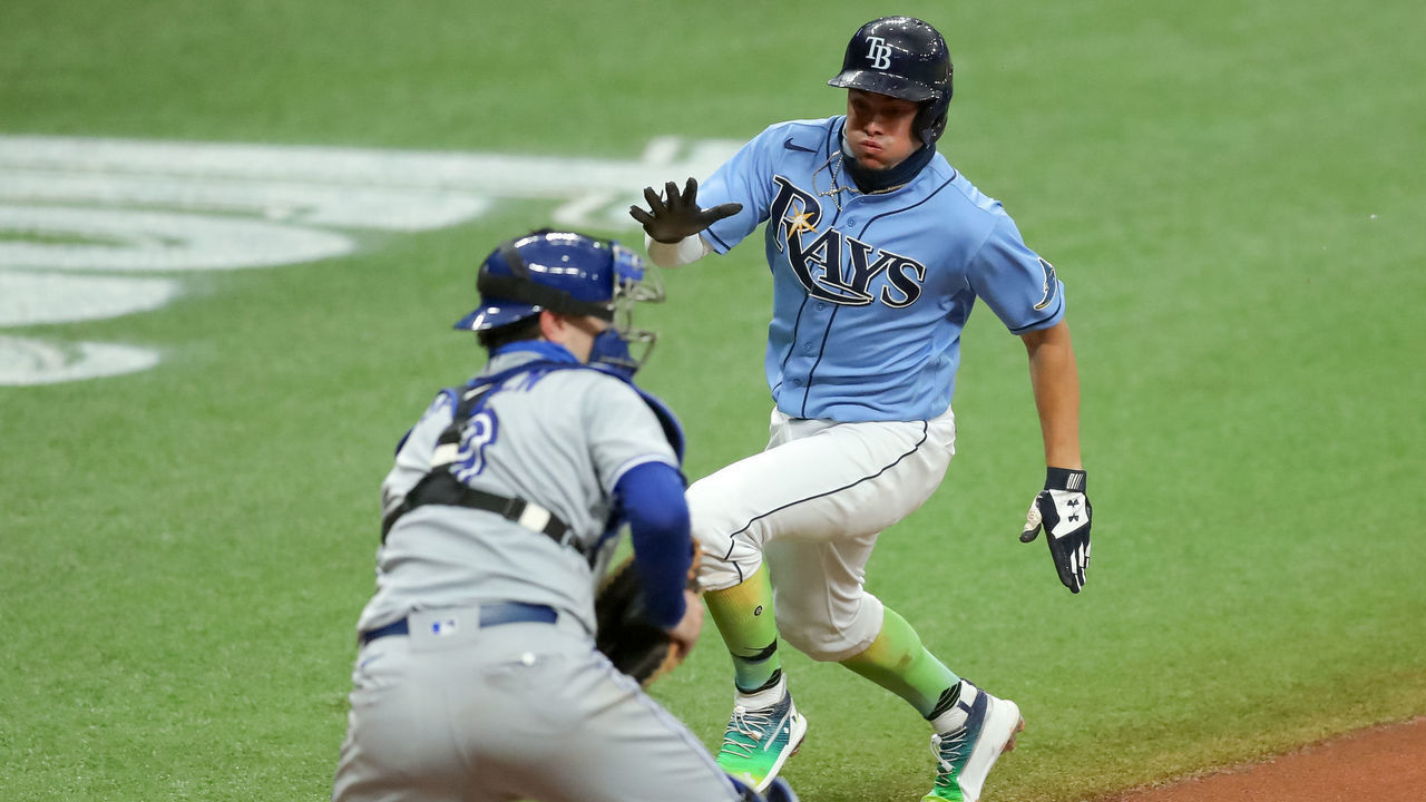 ST. PETERSBURG, FL - AUGUST 23: Willy Adames #1 of the Tampa Bay Rays comes in to score as Danny Jansen #9 of the Toronto Blue Jays waits a throw in the fifth inning of a baseball game at Tropicana Field on August 23, 2020 in St. Petersburg, Florida.