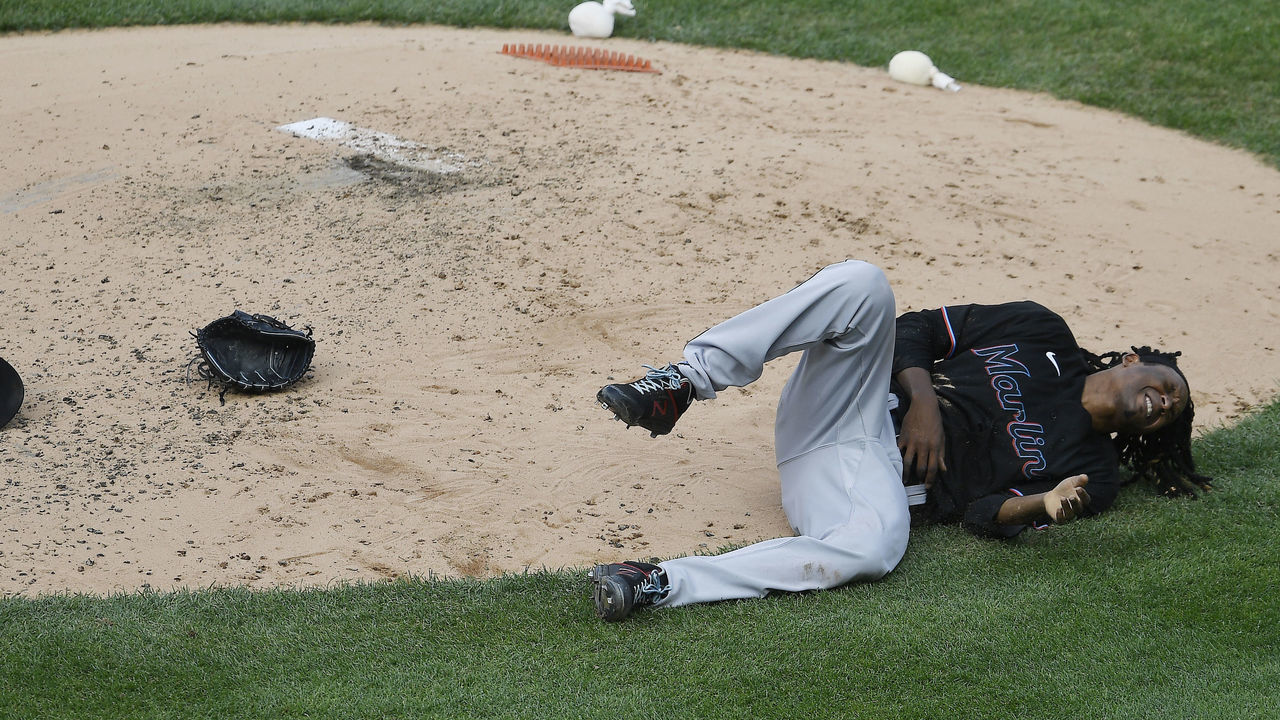NEW YORK, NEW YORK - SEPTEMBER 27: Jose Urena #62 of the Miami Marlins lies on the ground after being hit with the ball during the third inning against the New York Yankees at Yankee Stadium on September 27, 2020 in the Bronx borough of New York City.