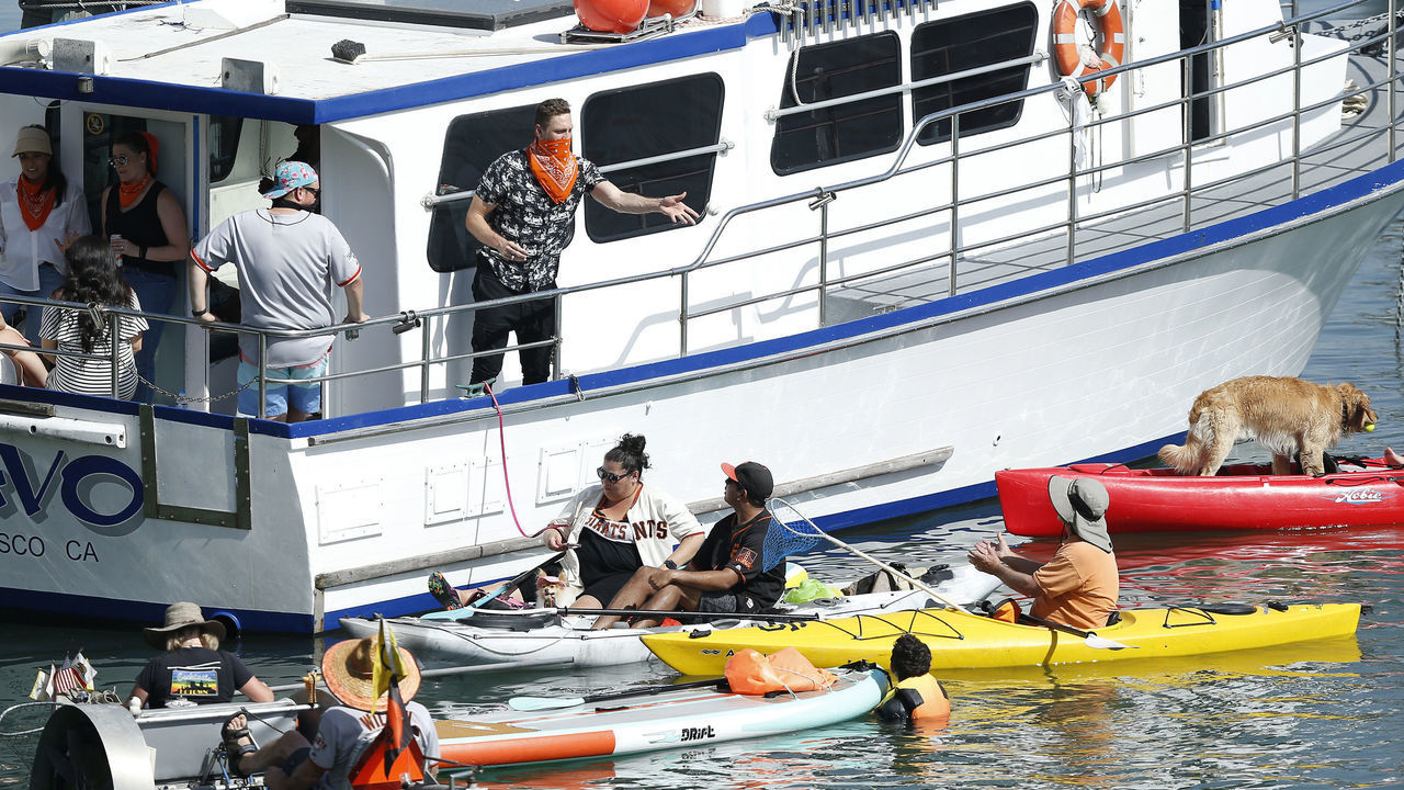 SAN FRANCISCO, CALIFORNIA - SEPTEMBER 27: Retired San Francisco Giants player Hunter Pence throws a signed ball to a fan from a boat in McCovey Cove outside the Stadium during the game between the San Francisco Giants and the San Diego Padres at Oracle Park on September 27, 2020 in San Francisco, California.