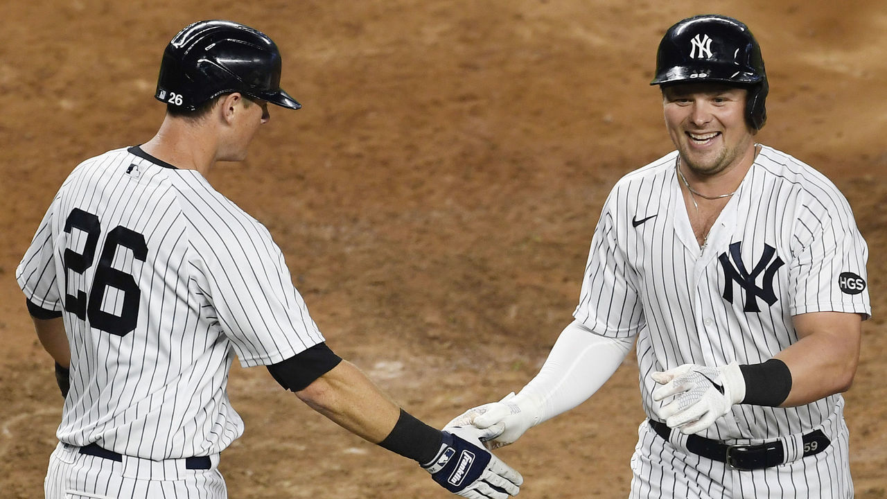 NEW YORK, NEW YORK - SEPTEMBER 16: Luke Voit #59 reacts with DJ LeMahieu #26 of the New York Yankees after hitting a home run during the sixth inning against the Toronto Blue Jays at Yankee Stadium on September 16, 2020 in the Bronx borough of New York City.