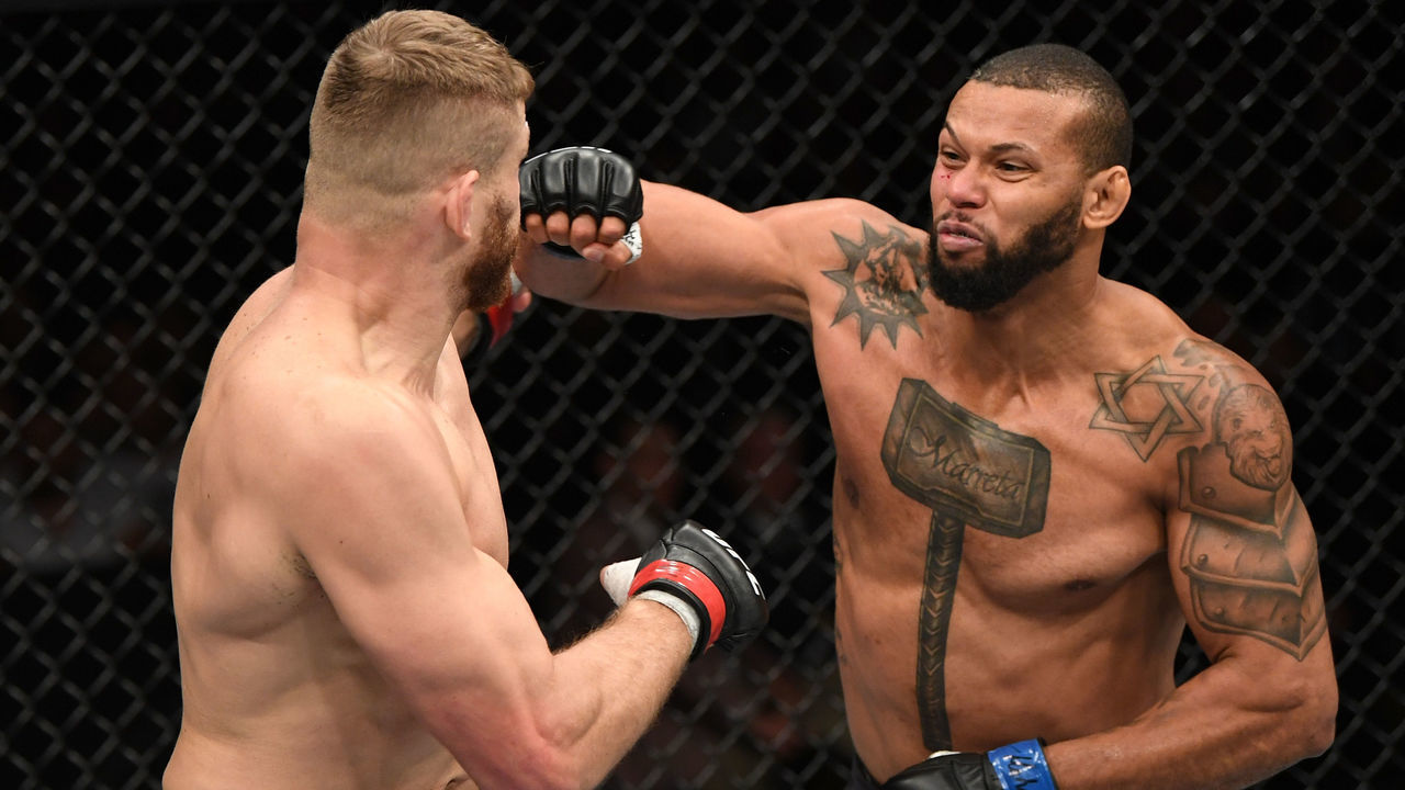 PRAGUE, CZECH REPUBLIC - FEBRUARY 23: (R-L) Thiago Santos of Brazil punches Jan Blachowicz of Poland in their light heavyweight bout during the UFC Fight Night event at O2 Arena on February 23, 2019 in the Prague, Czech Republic.