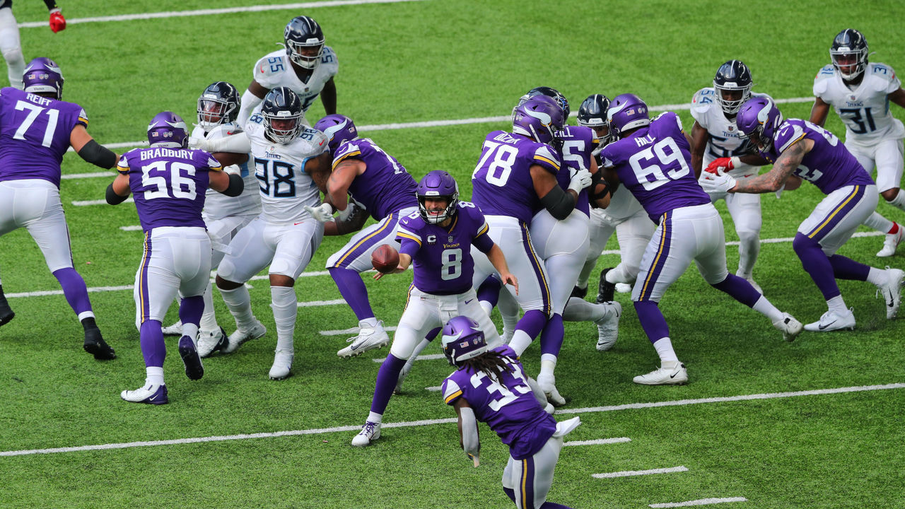 MINNEAPOLIS, MN - SEPTEMBER 27: Kirk Cousins #8 tosses the ball to Dalvin Cook #33 of the Minnesota Vikings against the Tennessee Titans in the third quarter at U.S. Bank Stadium on September 27, 2020 in Minneapolis, Minnesota.