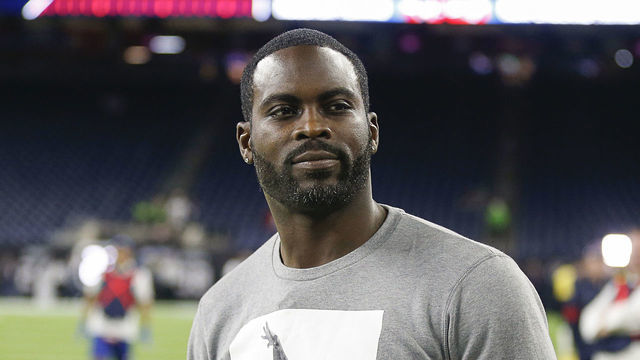 HOUSTON, TEXAS - DECEMBER 01: Former quarterback Michael Vick on the sidelines before the Houston Texans play the New England Patriots at NRG Stadium on December 01, 2019 in Houston, Texas.