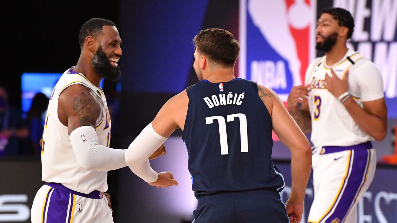 ORLANDO, FL - JULY 23: LeBron James #23 of the Los Angeles Lakers high-fives Luka Doncic #77 of the Dallas Mavericks before the game on July 23, 2020 at the Visa Athletic Center at ESPN Wide World of Sports Complex in Orlando, Florida. Mandatory Copyright Notice: Copyright 2020 NBAE