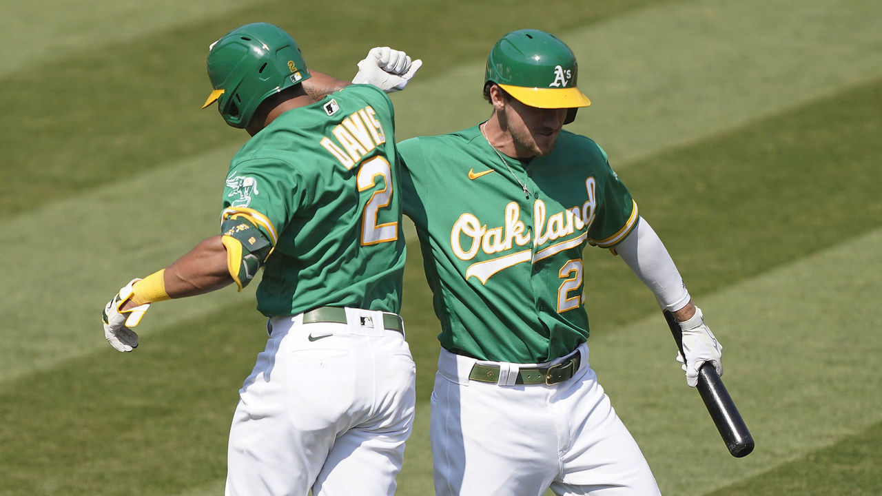 OAKLAND, CALIFORNIA - SEPTEMBER 30: Khris Davis #2 of the Oakland Athletics is congratulated by Stephen Piscotty #25 after Davis hit a solo home against the Chicago White Sox during the fourth inning of Game Two of the American League Wild Card Round at RingCentral Coliseum on September 30, 2020 in Oakland, California.