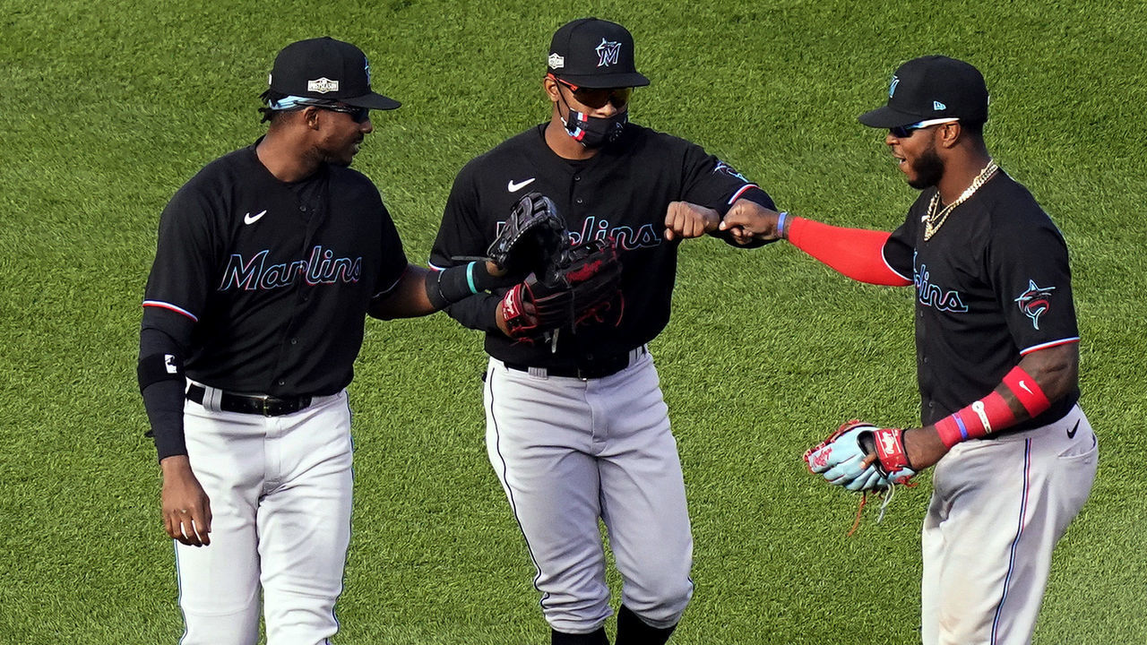CHICAGO, IL - SEPTEMBER 30: Magneuris Sierra #34, Monte Harrison #4 and Lewis Brinson #25 of the Miami Marlins celebrate after winning Game 1 of the Wild Card Series 5-1 against the Chicago Cubs at Wrigley Field on Wednesday, September 30, 2020 in Chicago, Illinois.