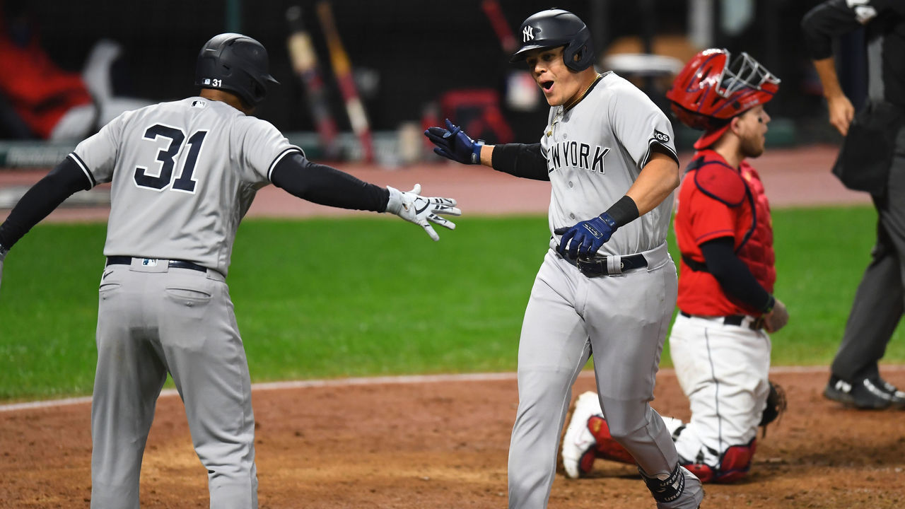CLEVELAND, OH - SEPTEMBER 30: Gio Urshela #29 of the New York Yankees is greeted by teammate Aaron Hicks #31 after hitting a grand slam in the fourth inning during Game 2 of the Wild Card Series between the New York Yankees and the Cleveland Indians at Progressive Field on Wednesday, September 30, 2020 in Cleveland, Ohio.