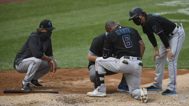 NEW YORK, NEW YORK - SEPTEMBER 27: Starling Marte #6 of the Miami Marlins is tended to by coaching staff after being hit by a pitch during the second inning against the New York Yankees at Yankee Stadium on September 27, 2020 in the Bronx borough of New York City.
