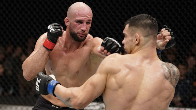 BUSAN, SOUTH KOREA - DECEMBER 21: (L-R) Volkan Oezdemir of Switzerland punches Aleksandar Rakic of Austria in their light heavyweight fight during the UFC Fight Night event at Sajik Arena 3 on December 21, 2019 in Busan, South Korea.