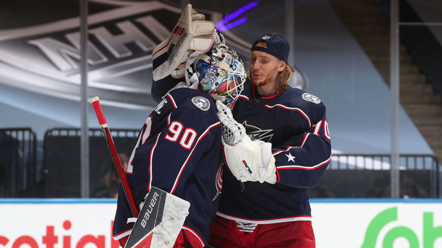 TORONTO, ONTARIO - JULY 30: Goaltender Joonas Korpisalo #70 of the Columbus Blue Jackets congratulates fellow netminder Elvis Merzlikins #90 after an exhibition game against the Boston Bruins prior to the 2020 NHL Stanley Cup Playoffs at Scotiabank Arena on July 30, 2020 in Toronto, Ontario. The Blue Jackets defeated the Bruins 4-1.