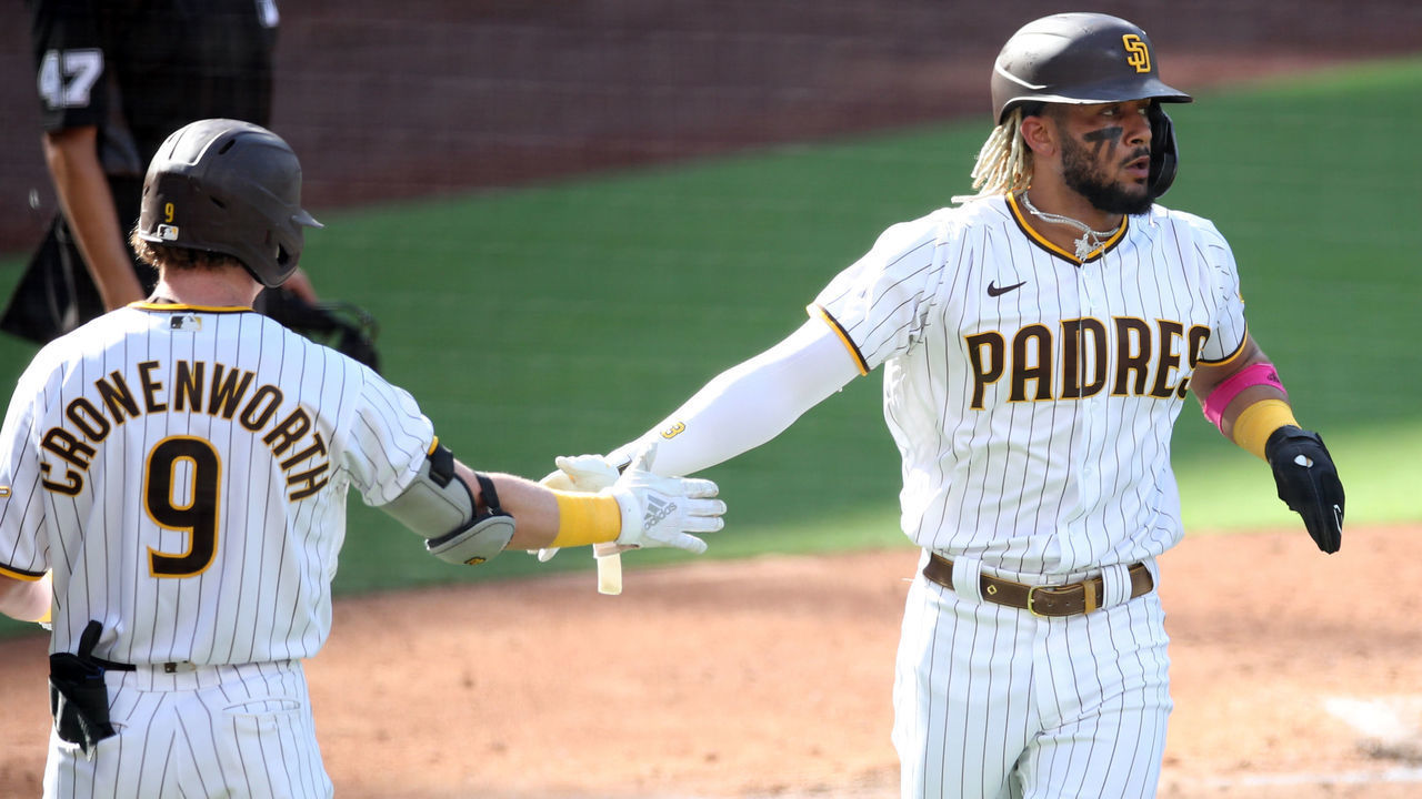 SAN DIEGO, CA - SEPTEMBER 30: Jake Cronenworth #9 congratulates Fernando Tatis Jr. #23 of the San Diego Padres on scoring in the third inning of Game 1 of the Wild Card Series between the St. Louis Cardinals and the San Diego Padres at Petco Park on Wednesday, September 30, 2020 in San Diego, California.