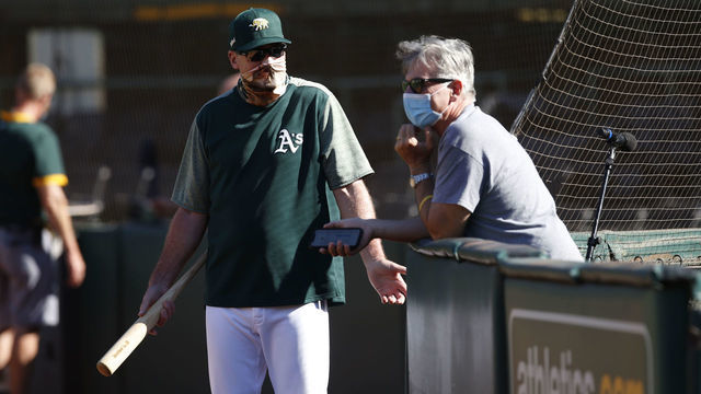 OAKLAND, CA - JULY 9: Manager Bob Melvin #6 and Executive Vice President of Baseball Operations Billy Beane of the Oakland Athletics talk on the field during summer workouts at RingCentral Coliseum on July 9, 2020 in Oakland, California.