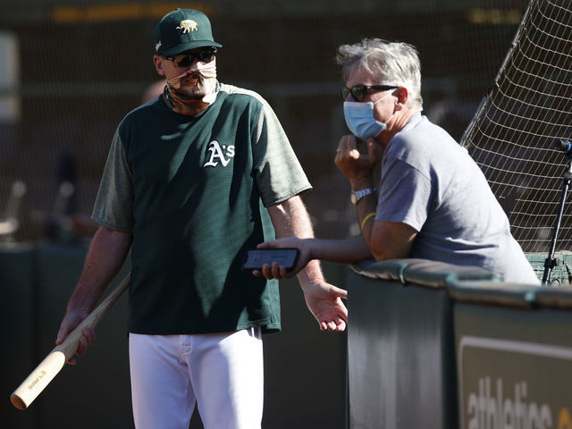 OAKLAND, CA - JULY 9: Manager Bob Melvin #6 and Executive Vice President of Baseball Operations Billy Beane of the Oakland Athletics talk on the field during summer workouts at RingCentral Coliseum on July 9, 2020 in Oakland, California.