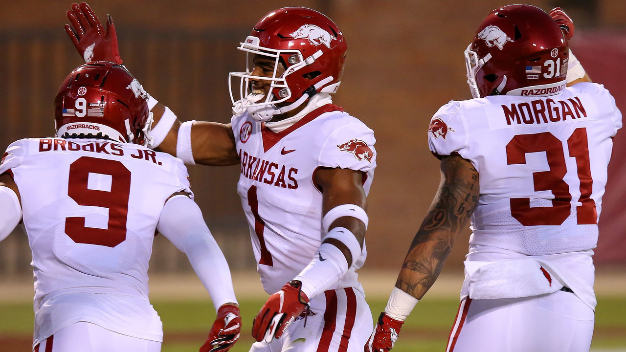 STARKVILLE, MISSISSIPPI - OCTOBER 03: Greg Brooks Jr. #9 of the Arkansas Razorbacks celebrates an interception returned for a touchdown with Jalen Catalon #1 against the Mississippi State Bulldogs during the first half at Davis Wade Stadium on October 03, 2020 in Starkville, Mississippi.