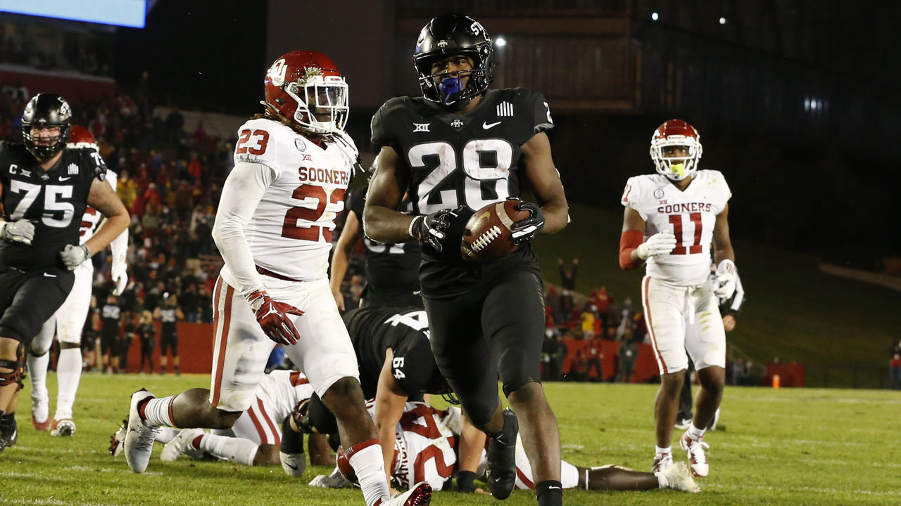 AMES, IA - OCTOBER 3: Running back Breece Hall #28 of the Iowa State Cyclones scores a touchdown as linebacker DaShaun White #23, and linebacker Nik Bonitto #11 of the Oklahoma Sooners defend in the second half of the play at Jack Trice Stadium on October 3, 2020 in Ames, Iowa. The Iowa State Cyclones won 37-30 over the Oklahoma Sooners.