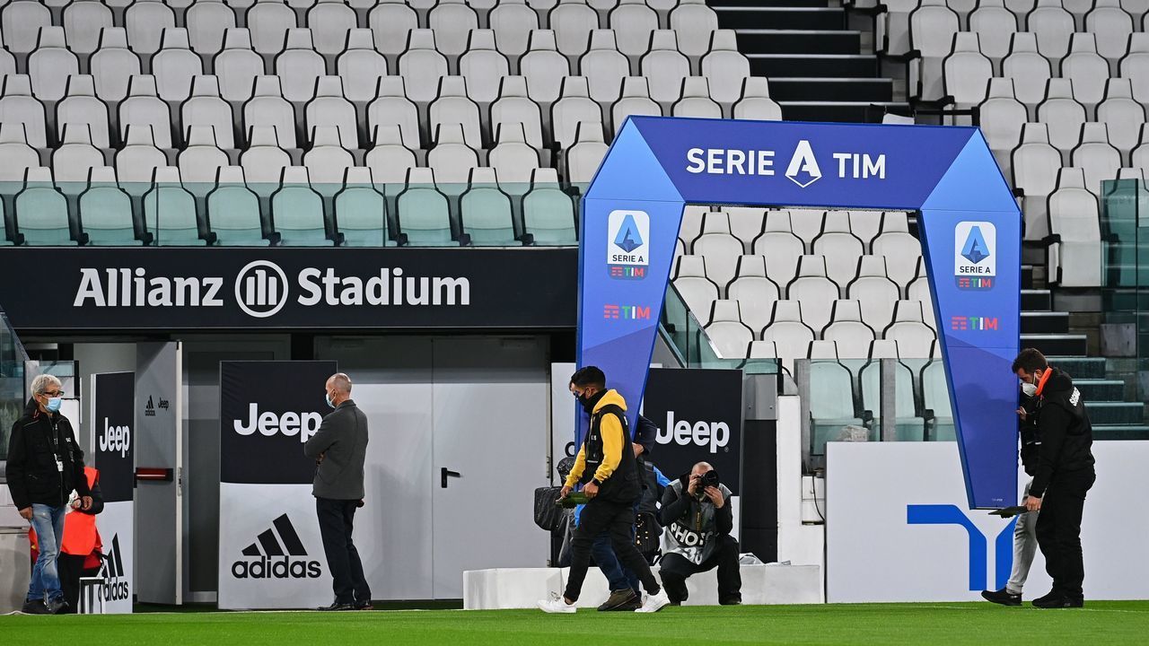 Workers remove the archway structure under which players usually enter the pitch before the start of the game, on October 4, 2020 at the Juventus stadium in Turin, prior to the Italian Serie A football match Juventus vs Napoli, still scheduled following Lega Serie A's confirmation despite Napoli remaining at home in Naples. - Napoli remained in Naples, complying with a decision by regional health authorities, as Juventus confirmed they would "take to the field" as scheduled despite two positive tests among their staff. If Napoli do not play they would forfeit the game 3-0.