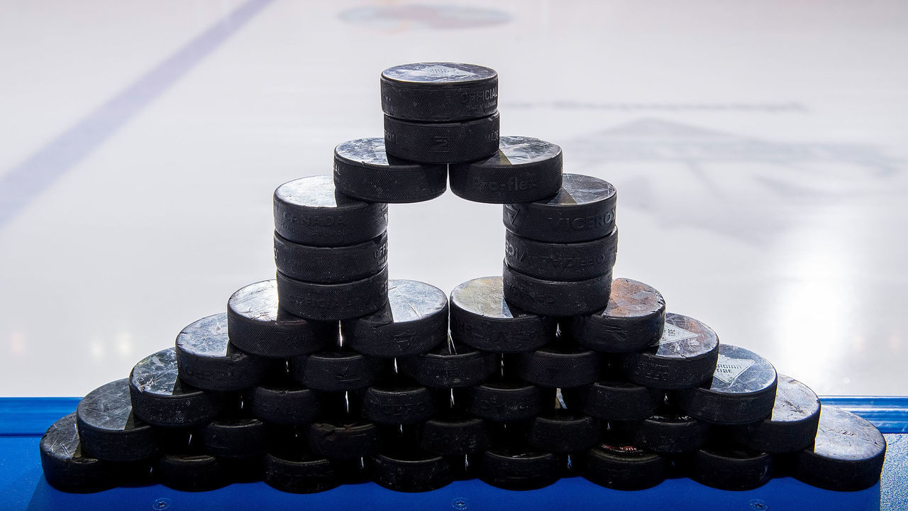 KELOWNA, BC - JANUARY 09: A stack of pucks stand on the boards at the bench prior to warm up between the Kelowna Rockets against the Everett Silvertips at Prospera Place on January 9, 2019 in Kelowna, Canada.