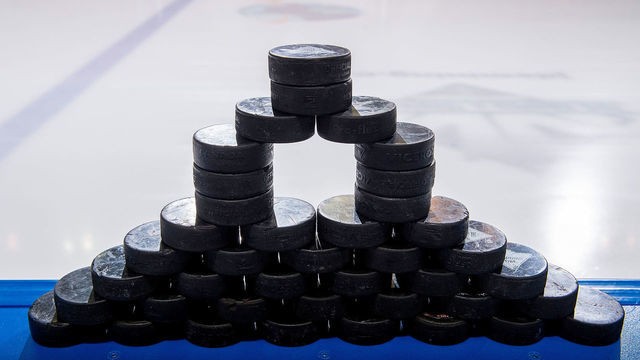 KELOWNA, BC - JANUARY 09: A stack of pucks stand on the boards at the bench prior to warm up between the Kelowna Rockets against the Everett Silvertips at Prospera Place on January 9, 2019 in Kelowna, Canada.