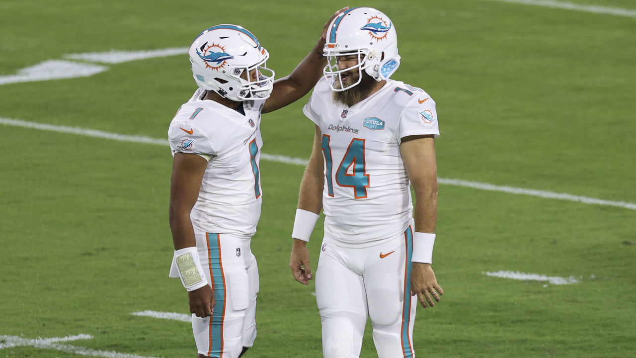 JACKSONVILLE, FLORIDA - SEPTEMBER 24: Tua Tagovailoa #1 of the Miami Dolphins talks with teammate Ryan Fitzpatrick #14 before the start of the game against the Jacksonville Jaguars at TIAA Bank Field on September 24, 2020 in Jacksonville, Florida.