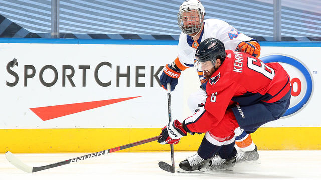 TORONTO, ONTARIO - AUGUST 12: Leo Komarov #47 of the New York Islanders skates against Michal Kempny #6 of the Washington Capitals in the first period of Game One of the Eastern Conference First Round of the 2020 NHL Stanley Cup Playoff at Scotiabank Arena on August 12, 2020 in Toronto, Ontario.