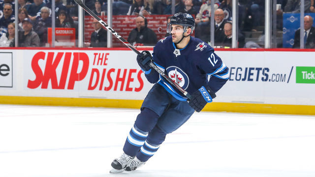 WINNIPEG, MB - MARCH 6: Dylan DeMelo #12 of the Winnipeg Jets keeps an eye on the play during second period action against the Vegas Golden Knights at the Bell MTS Place on March 6, 2020 in Winnipeg, Manitoba, Canada. The Jets shutout the Knights 4-0.