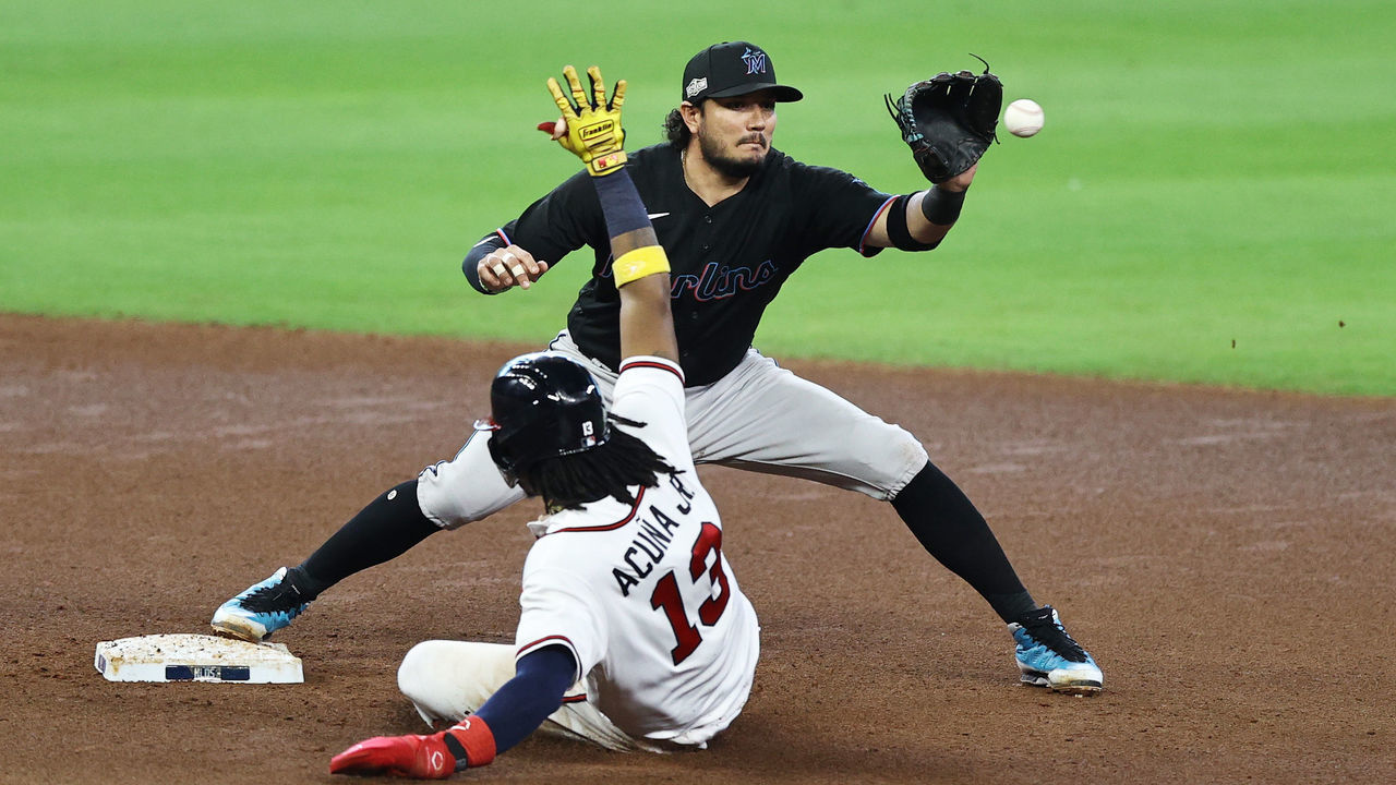 HOUSTON, TEXAS - OCTOBER 06: Ronald Acuna Jr. #13 of the Atlanta Braves is out by Miguel Rojas #19 of the Miami Marlins at second during the seventh inning in Game One of the National League Division Series at Minute Maid Park on October 06, 2020 in Houston, Texas.
