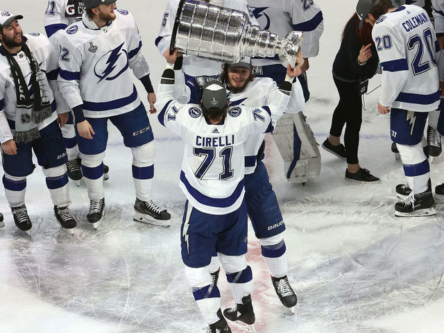 EDMONTON, ALBERTA - SEPTEMBER 28: Anthony Cirelli #71 of the Tampa Bay Lightning hands off the Stanley Cup to Mikhail Sergachev #98 following the series-winning victory over the Dallas Stars in Game Six of the 2020 NHL Stanley Cup Final at Rogers Place on September 28, 2020 in Edmonton, Alberta, Canada.