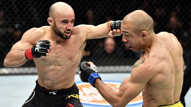 LAS VEGAS, NEVADA - DECEMBER 14: (L-R) Marlon Moraes of Brazil punches Jose Aldo of Brazil in their bantamweight bout during the UFC 245 event at T-Mobile Arena on December 14, 2019 in Las Vegas, Nevada.