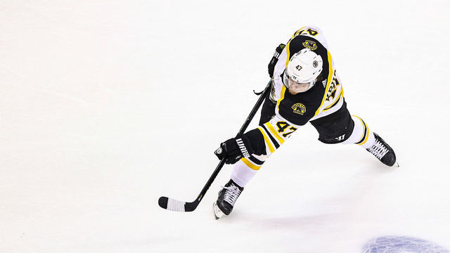 TORONTO, ONTARIO - AUGUST 15: Torey Krug #47 of the Boston Bruins attempts a shot against the Carolina Hurricanes during the second period in Game Three of the Eastern Conference First Round during the 2020 NHL Stanley Cup Playoffs at Scotiabank Arena on August 15, 2020 in Toronto, Ontario.