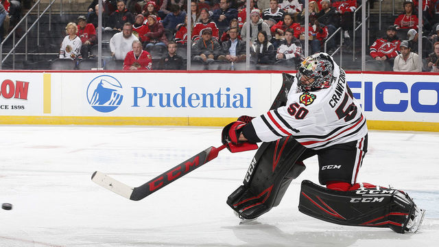 NEWARK, NJ - DECEMBER 6: Corey Crawford #50 of the Chicago Blackhawks plays the puck against the New Jersey Devils during the game at the Prudential Center on December 6, 2019 in Newark, New Jersey. "n"n"n