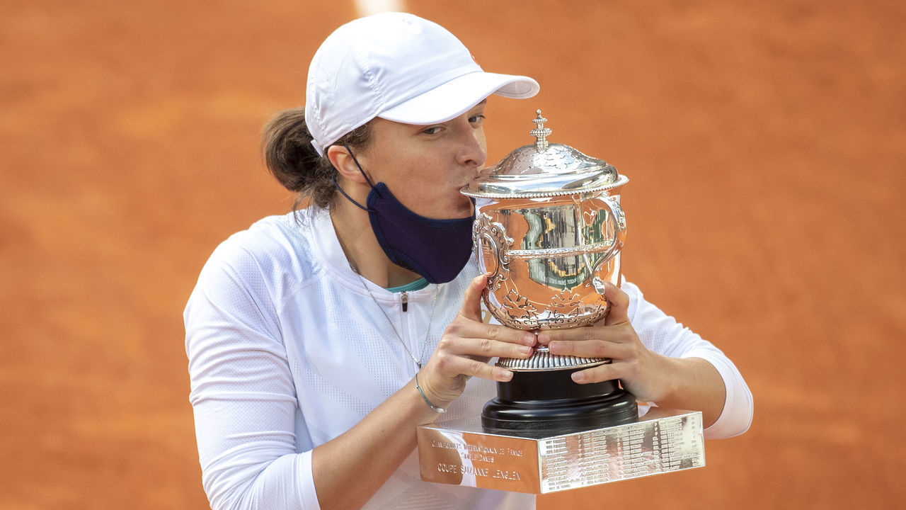 PARIS, FRANCE October 10. Iga Swiatek of Poland kisses the trophy after defeating Sofia Kenin of the United States in the Singles Final on Court Philippe-Chatrier during the French Open Tennis Tournament at Roland Garros on October 10th 2020 in Paris, France.