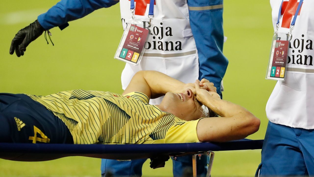 Colombia's Santiago Arias is taken on a stretcher after suffering an injury during the 2022 FIFA World Cup South American qualifier football match against Venezuela at the Roberto Melendez Metropolitan Stadium in Barranquilla, Colombia, on October 9, 2020, amid the COVID-19 novel coronavirus pandemic.