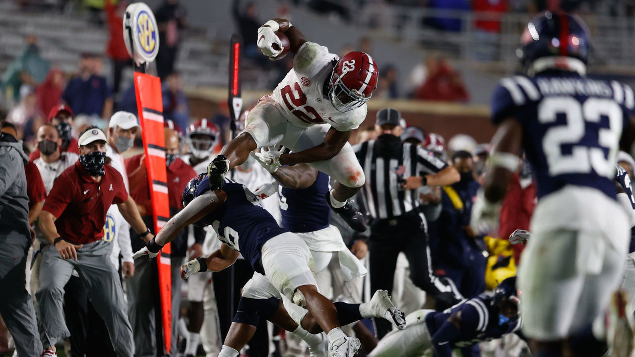 OXFORD, MS - OCTOBER 10: Najee Harris #22 of the Alabama Crimson Tide hurdles a defender for a gain against the Ole Miss Rebels at Vaught Hemingway Stadium on October 10, 2020 in Oxford, Mississippi.