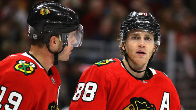 CHICAGO, ILLINOIS - DECEMBER 27: Jonathan Toews #19 of the Chicago Blackhawks talks with Patrick Kane #88 before a face-off against the New York Islanders at the United Center on December 27, 2019 in Chicago, Illinois. The Blackhawks defeated the Islanders 5-2.