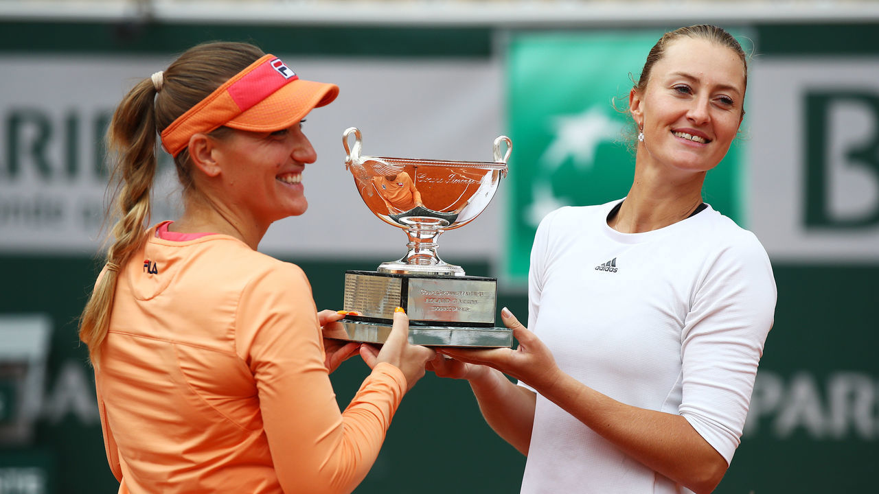 PARIS, FRANCE - OCTOBER 11: Timea Babos of Hungary (L) and Kristina Mladenovic of France lift the winners trophy following their victory in the Women's Doubles Final against Desirae Krawczyk of The United States of America and Alexa Guarachi of Chile on day fifteen of the 2020 French Open at Roland Garros on October 11, 2020 in Paris, France.