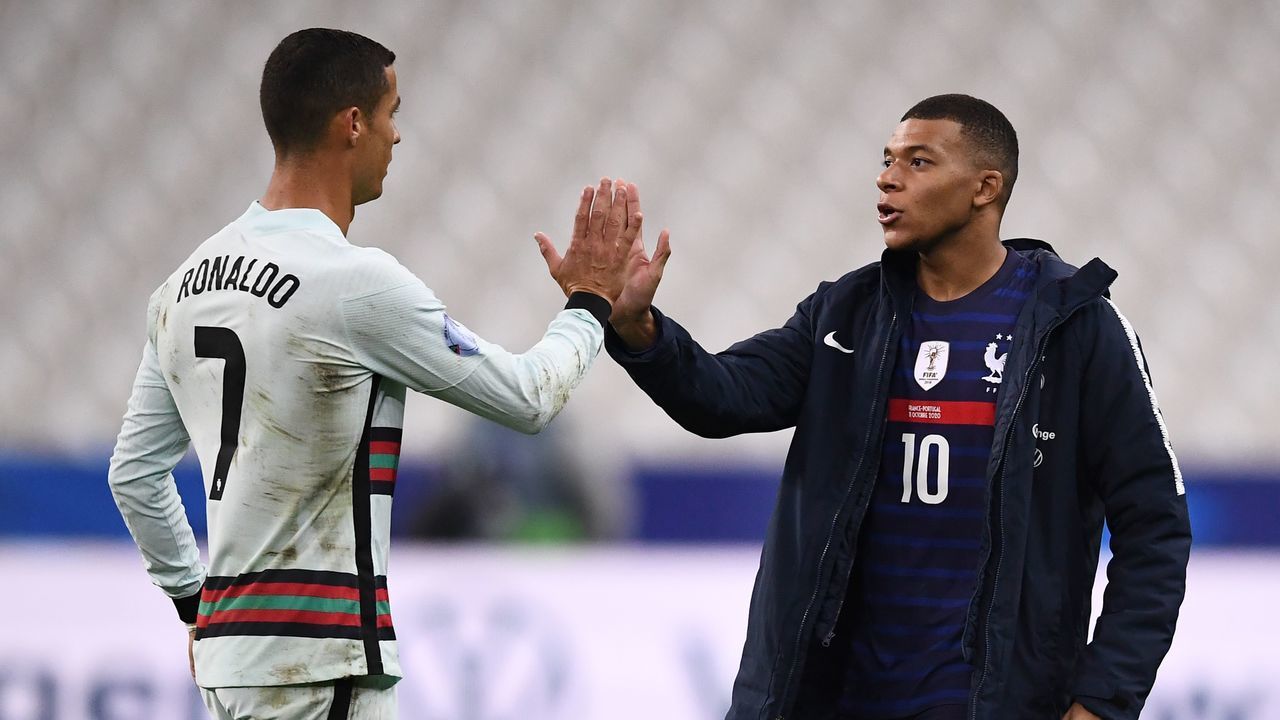 Portugal's forward Ronaldo (L) greets France's forward Kylian Mbappe at the end of the Nations League football match between France and Portugal, on October 11, 2020 at the Stade de France in Saint-Denis, outside Paris.