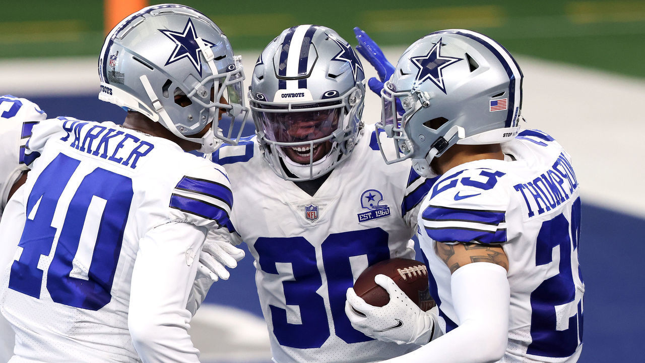 ARLINGTON, TEXAS - OCTOBER 11: Anthony Brown #30 of the Dallas Cowboys is congratulated by Steven Parker #40 and Darian Thompson #23 after returning a fumble for a touchdown against the New York Giants during the second quarter at AT&T Stadium on October 11, 2020 in Arlington, Texas.