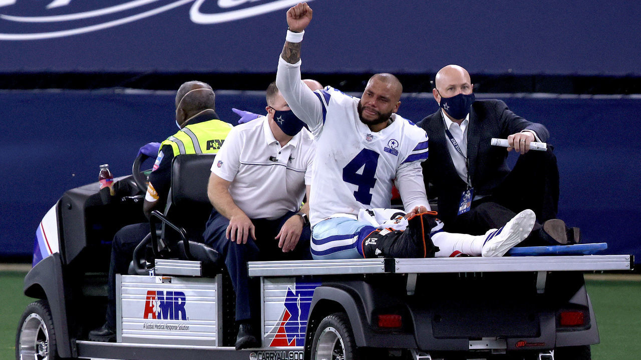ARLINGTON, TEXAS - OCTOBER 11: Dak Prescott #4 of the Dallas Cowboys is carted off the field after sustaining a leg injury against the New York Giants during the third quarter at AT&T Stadium on October 11, 2020 in Arlington, Texas.