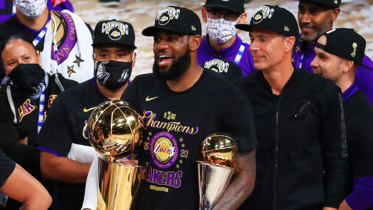 LAKE BUENA VISTA, FLORIDA - OCTOBER 11: LeBron James #23 of the Los Angeles Lakers reacts with his MVP trophy and Finals trophy after winning the 2020 NBA Championship over the Miami Heat in Game Six of the 2020 NBA Finals at AdventHealth Arena at the ESPN Wide World Of Sports Complex on October 11, 2020 in Lake Buena Vista, Florida.