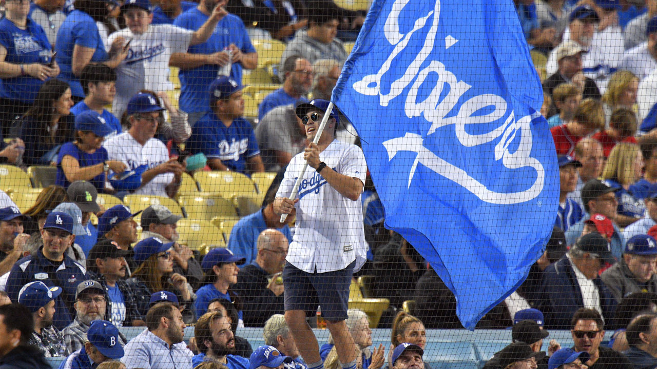 LOS ANGELES, CA - OCTOBER 04: Staffers wave Dodgers flags at the start of game 2 of the NLDS in Los Angeles on Friday, Oct. 4, 2019.
