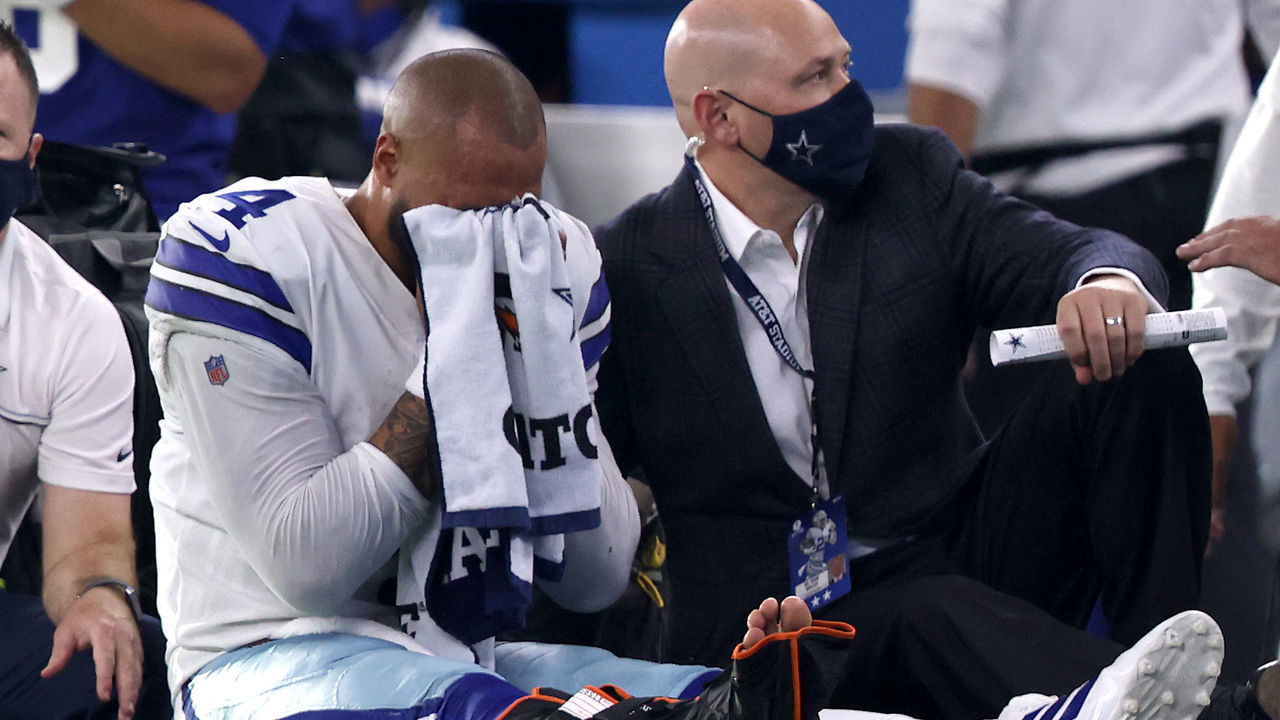 ARLINGTON, TEXAS - OCTOBER 11: Dak Prescott #4 of the Dallas Cowboys is carted off the field after sustaining a leg injury against the New York Giants during the third quarter at AT&T Stadium on October 11, 2020 in Arlington, Texas.