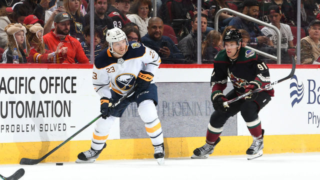 GLENDALE, ARIZONA - FEBRUARY 29: Sam Reinhart #23 of the Buffalo Sabres skates with the puck while being defended by Taylor Hall #91 of the Arizona Coyotes at Gila River Arena on February 29, 2020 in Glendale, Arizona.