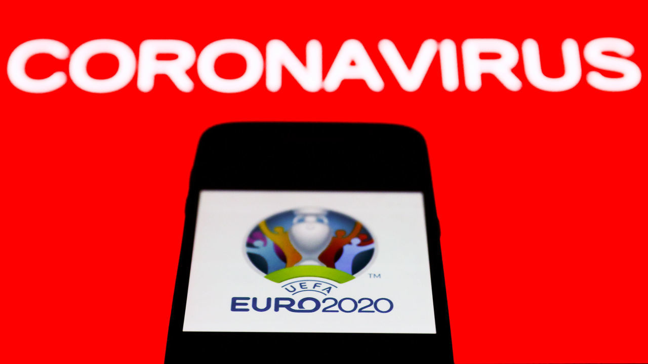 UEFA Euro 2020 app icon is seen on the smartphone screen with coronavirus sign in the background in this illustration photo taken in Poland on March 21, 2020.