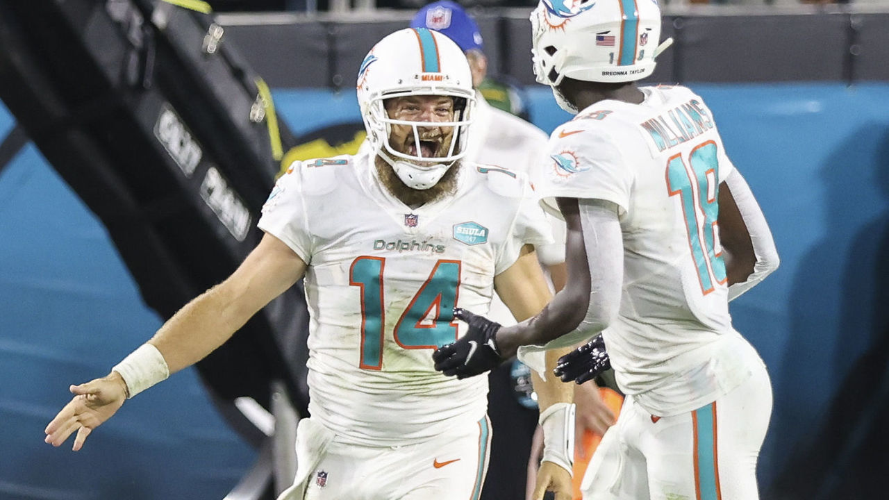 JACKSONVILLE, FLORIDA - SEPTEMBER 24: Ryan Fitzpatrick #14 of the Miami Dolphins celebrates with Preston Williams #18 after scoring a touchdown against the Jacksonville Jaguars at TIAA Bank Field on September 24, 2020 in Jacksonville, Florida.